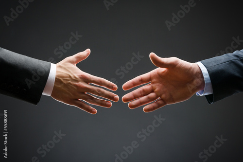 Foto Close up of forthcoming handshake of business people