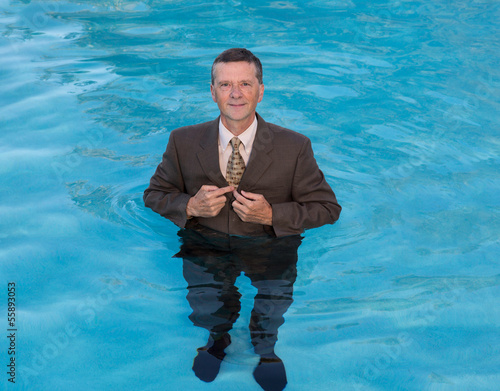 Senior business man in deep water photo