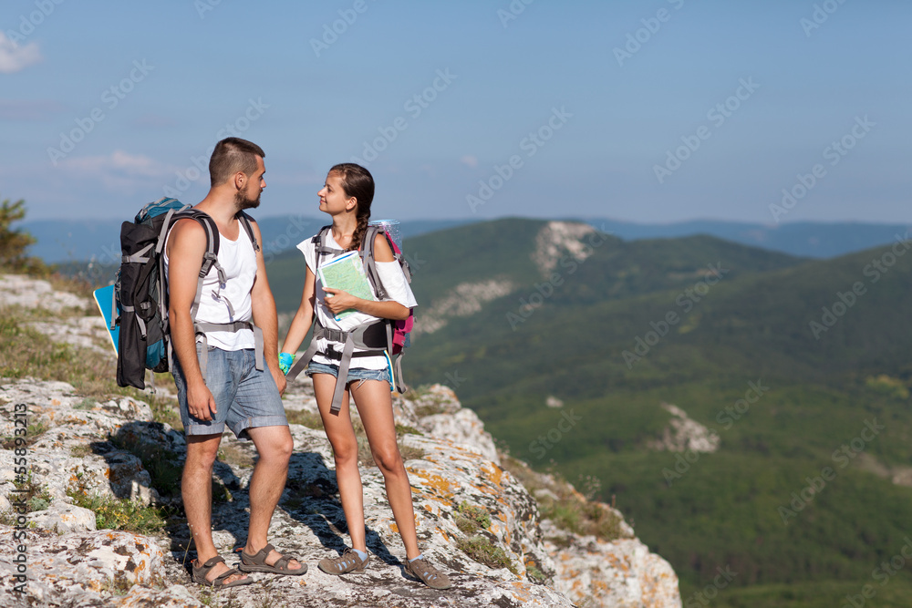 Hikers with backpacks enjoying valley 