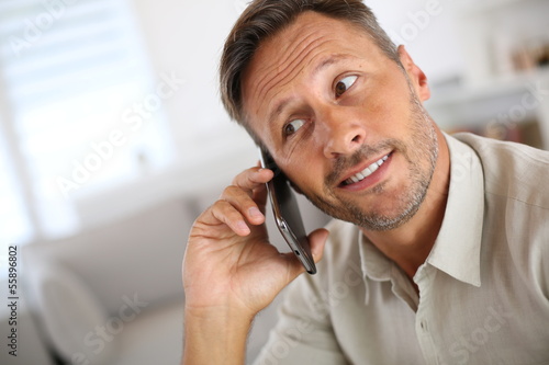 Smiling handsome guy talking on the phone