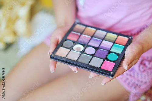 Makeup colorful eyeshadow palette in hands photo