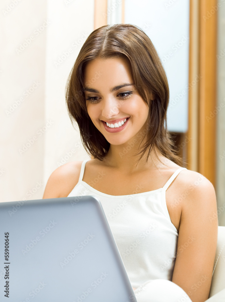 Cheerfull smiling woman working with laptop Cheerfull smiling woman working with laptop