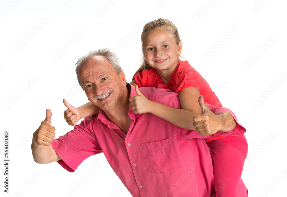 Portrait of a little girl enjoying piggyback ride with her grand Portrait of a little girl enjoying piggyback ride with her grand