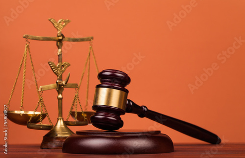 judge gavel and scales of justice on table