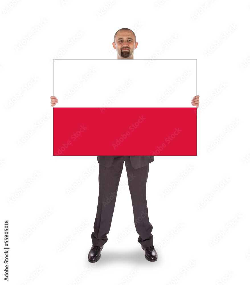 Obraz premium Smiling businessman holding a big card, flag of Poland