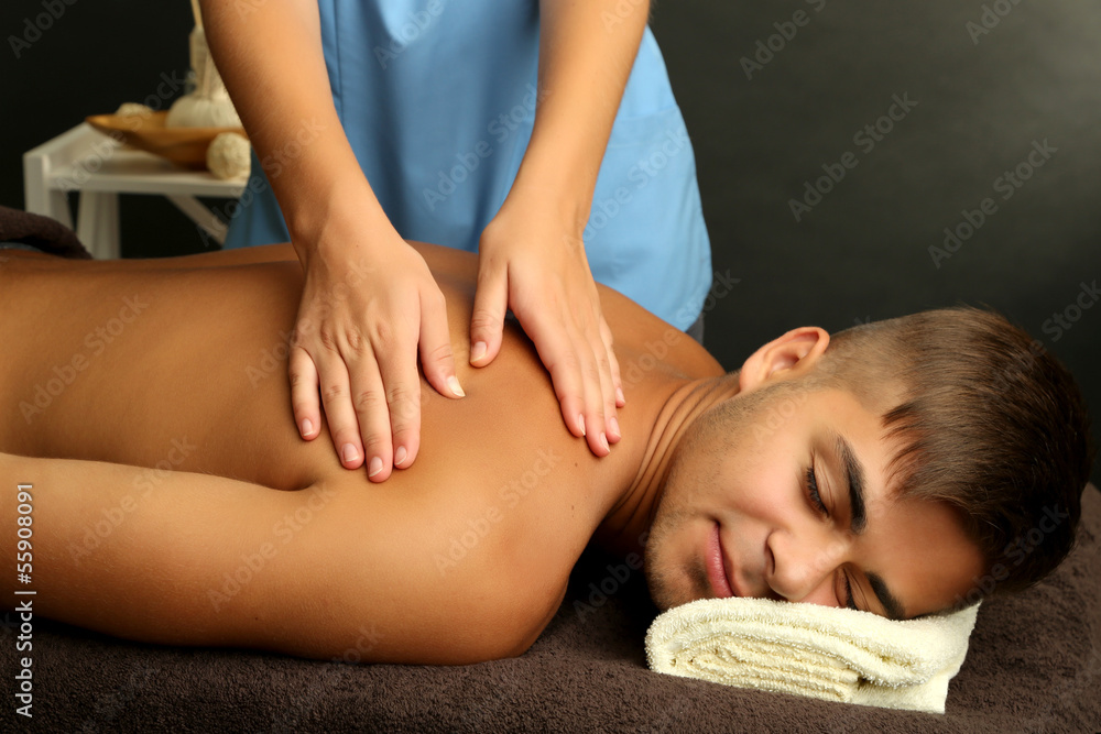 Fototapeta premium Young man having back massage close up