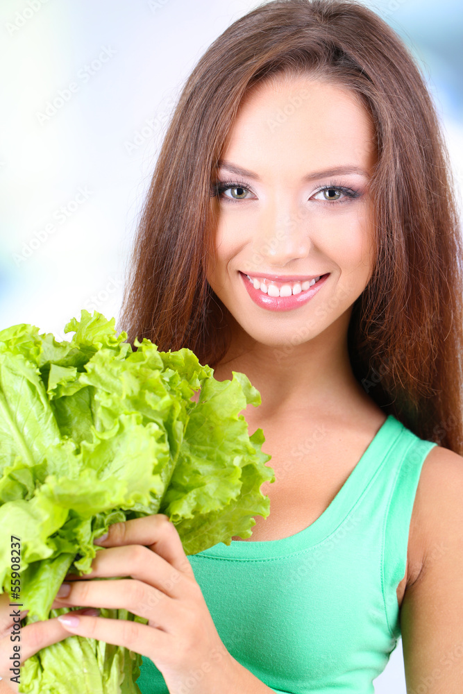 Beautiful girl with fresh salad on light background Beautiful girl with fresh salad on light background