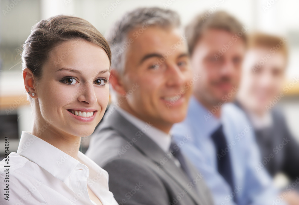 Smiling woman sitting at a business meeting with colleagues Smiling woman sitting at a business meeting with colleagues