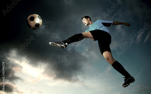 football player on soccer field of stadium with drammatic sky © Andrii IURLOV