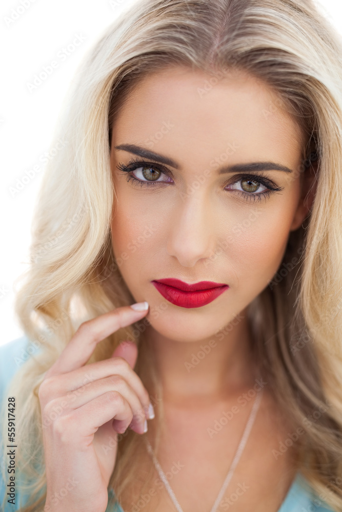 Portrait of a pensive blonde woman in blue dress looking at came Portrait of a pensive blonde woman in blue dress looking at came