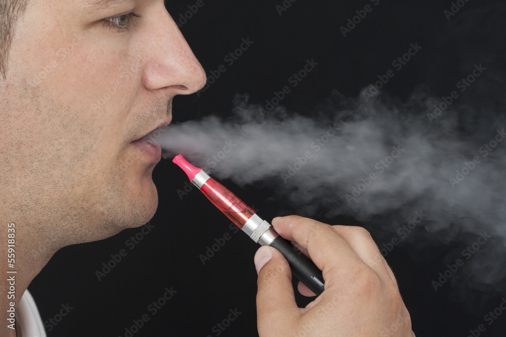 Fototapeta premium Young Man Smokin Electic Cigarette