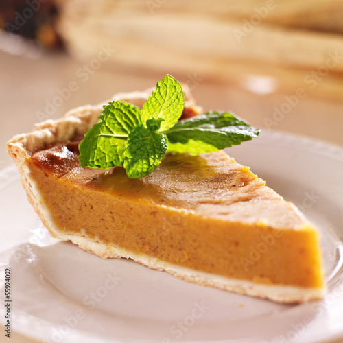pumpkin pie with mint garnish closeup