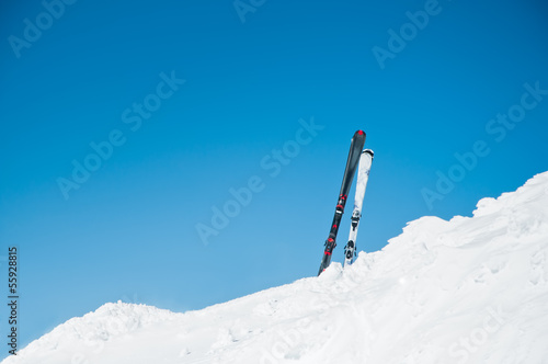 skis on slope, on winter resort against clear, blue sky
