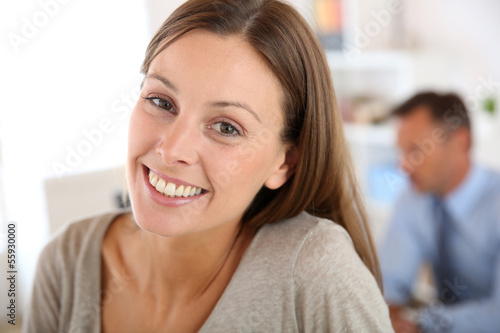 Smiling young woman in office