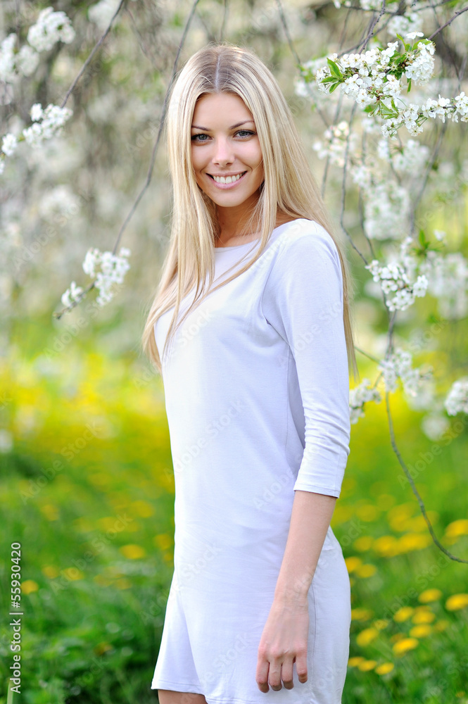 Beautiful smiling woman portrait in a garden Beautiful smiling woman portrait in a garden