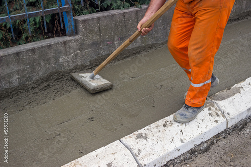 Worker leveling fresh Concrete 3