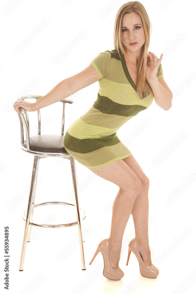 Woman green stripe dress sit barely on chair