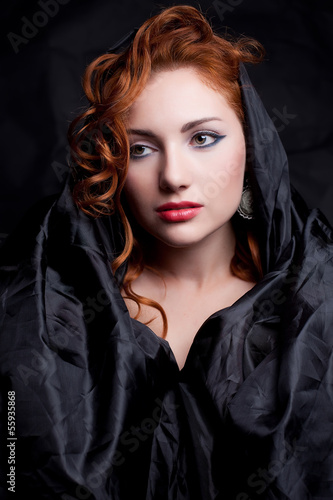 Vintage portrait of a glamourous red-haired queen like girl © Augustino