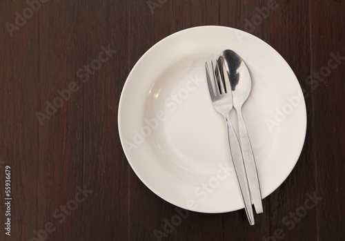 Silverware and plate on table