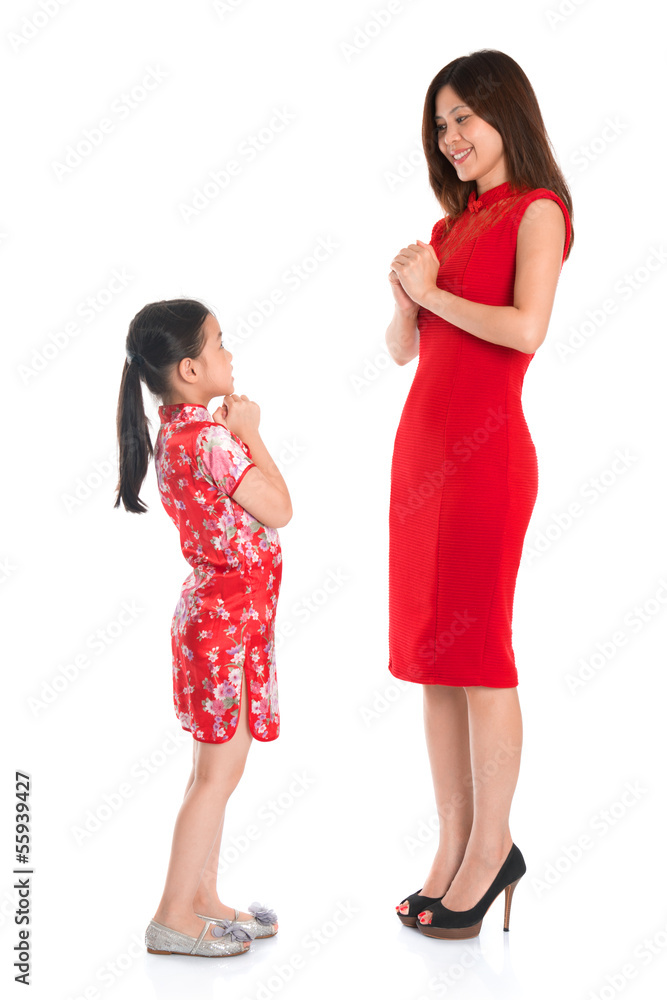 Full length Chinese parent and child greeting to each other Full length Chinese parent and child greeting to each other