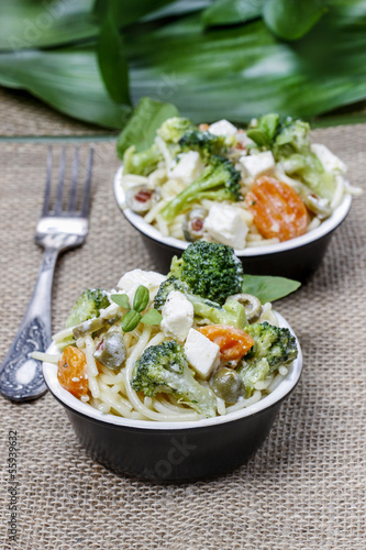 Vegetarian pasta with broccoli, ricotta, basil, carrot and olive