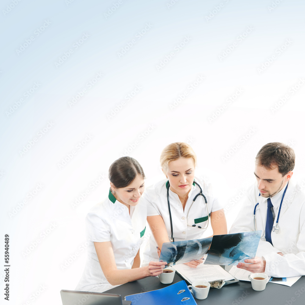 A group of young medical workers together in white clothes A group of young medical workers together in white clothes