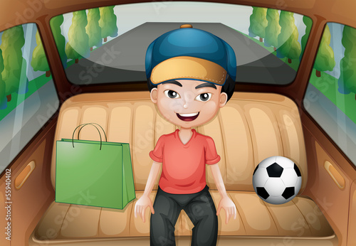 A boy sitting inside a running car