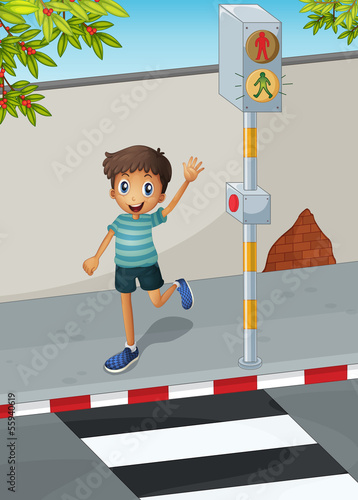A happy boy waving his hand near the pedestrian lane