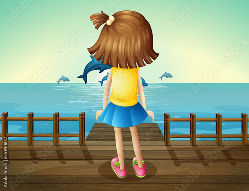 A young girl watching the dolphins