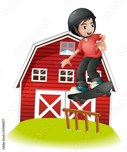 A boy skating in front of the red barnhouse