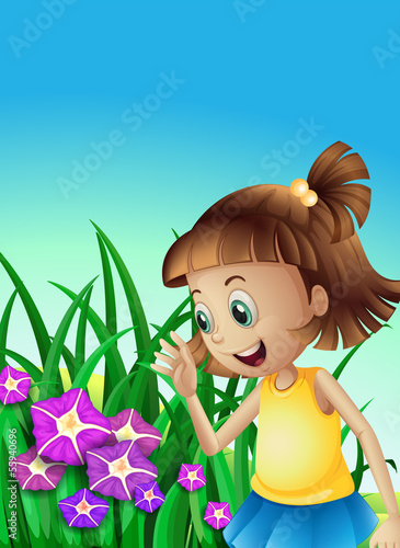 A girl watching the violet flowers in the garden