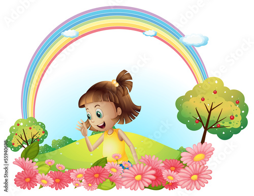 A smiling girl at the garden with pink blooming flowers