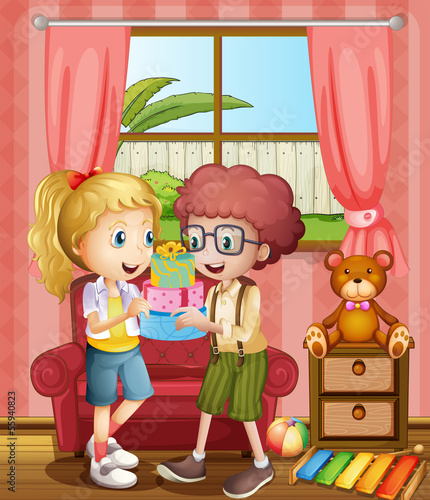 A boy and a girl holding gifts inside the house