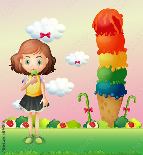 A girl eating an icecream beside a giant icecream