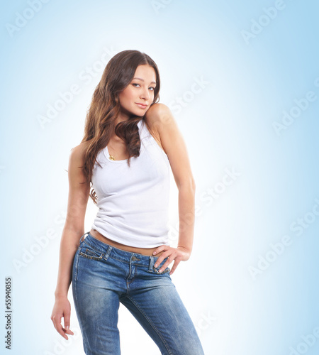 A young and sexy brunette woman posing in stylish jeans © Acronym