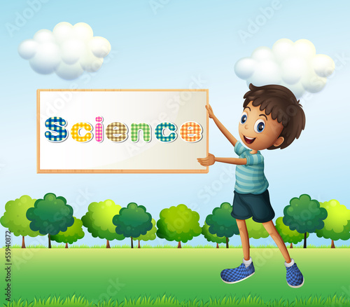 A boy holding a science signage