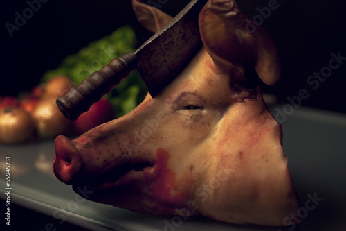 Pig head with a hatchet photo