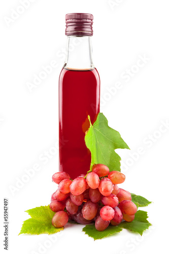 Glass bottle of red wine vinegar with grapes