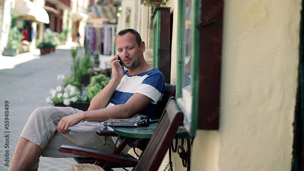 Young man talking on cellphone in the city