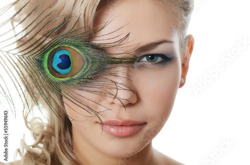 The beautiful woman with feathers of a peacock