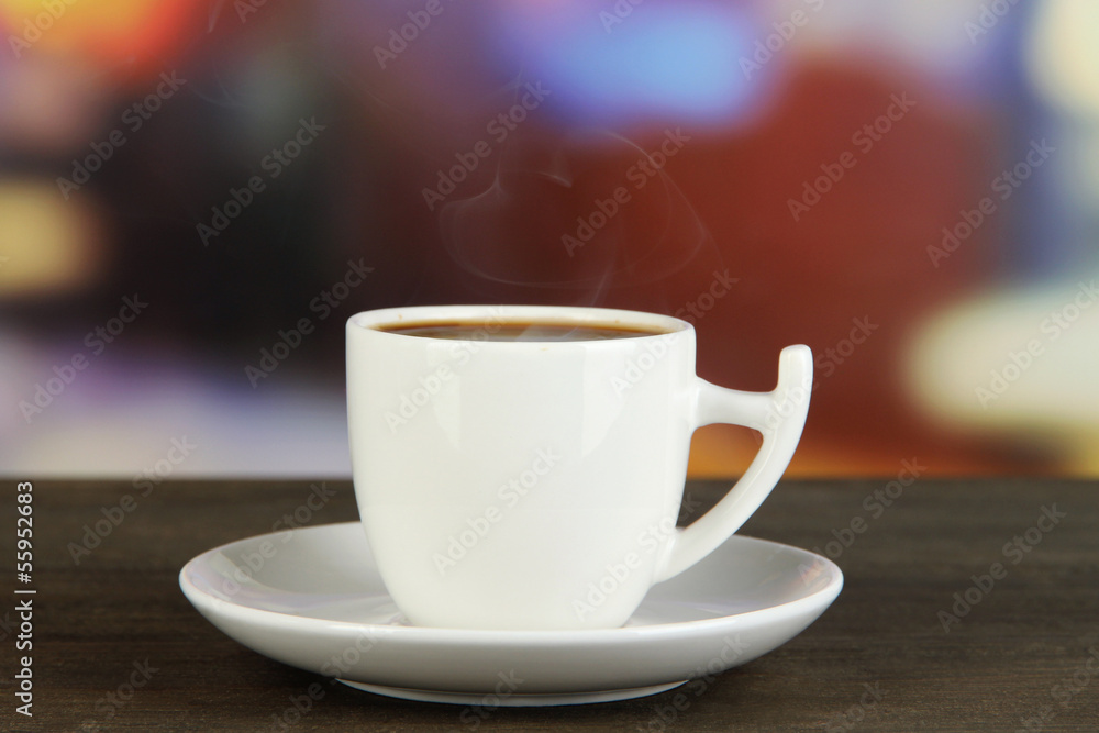 Cup of coffee on wooden table on bright background Cup of coffee on wooden table on bright background
