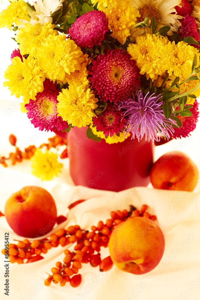 Still life with autumnal flowers and fruits