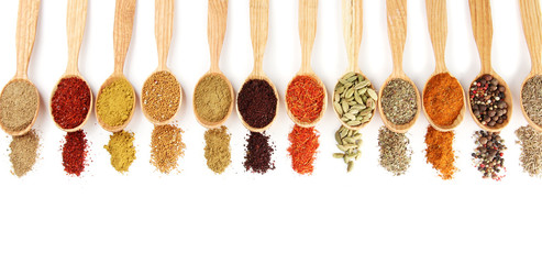 Fototapete Gewürze Assortment of spices in wooden spoons, isolated on white  © Africa Studio