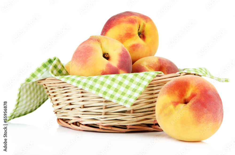 Ripe sweet peaches in wicker basket, isolated on white Ripe sweet peaches in wicker basket, isolated on white