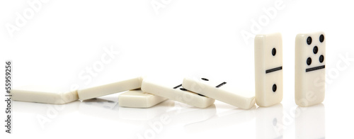 Domino effect - Row of white dominoes on white background photo