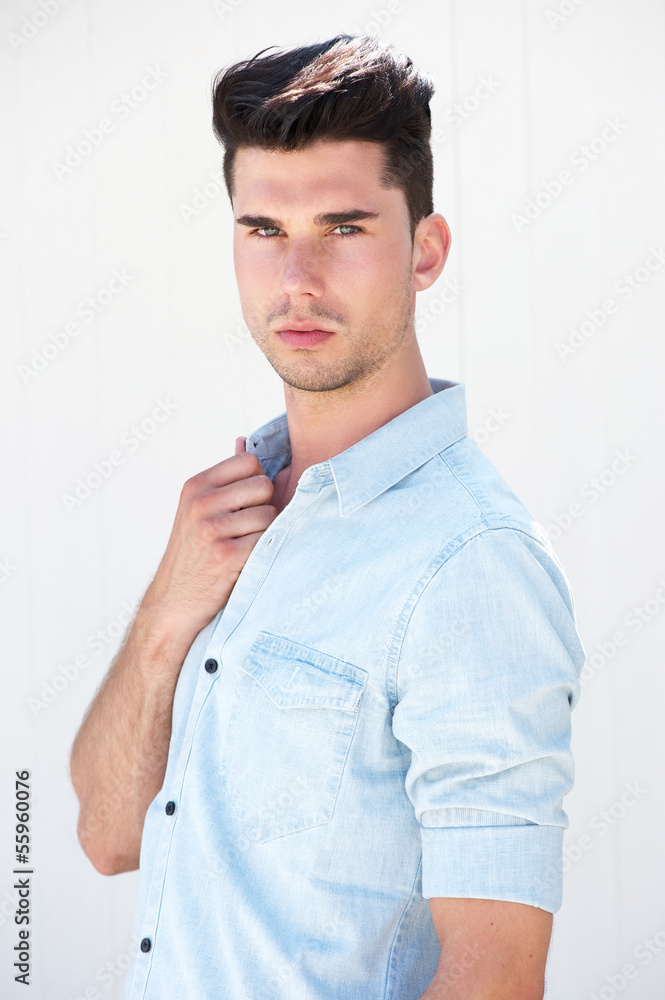 Attractive male fashion model standing on white background Attractive male fashion model standing on white background