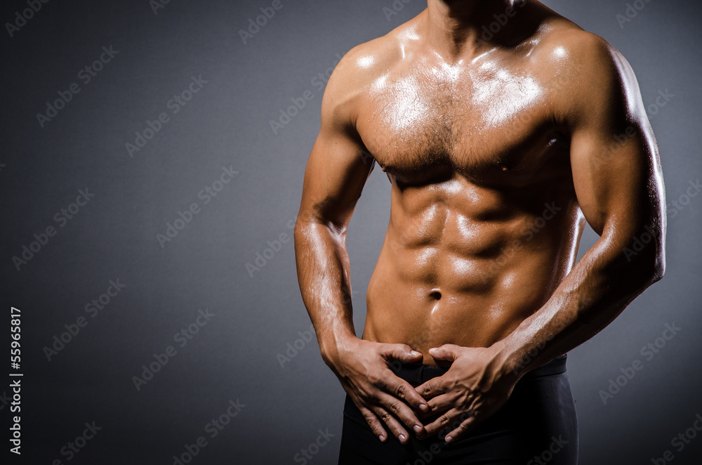 Ripped young man in bodybuilding concept