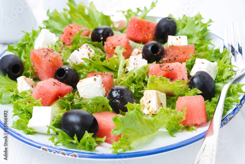 fresh salad with watermelon, feta cheese and olives, close-up