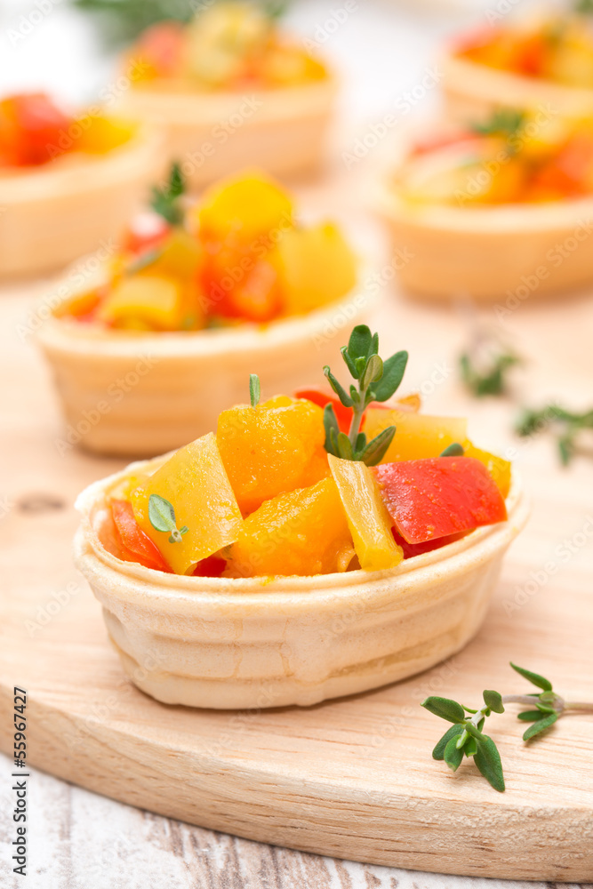 tartlets with roasted vegetables and thyme on board, close-up tartlets with roasted vegetables and thyme on board, close-up