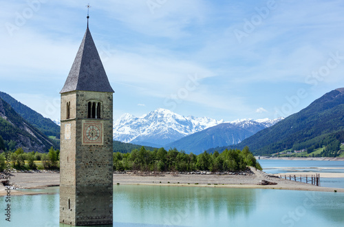 The bell tower in Reschensee and family (Italy). © wildman